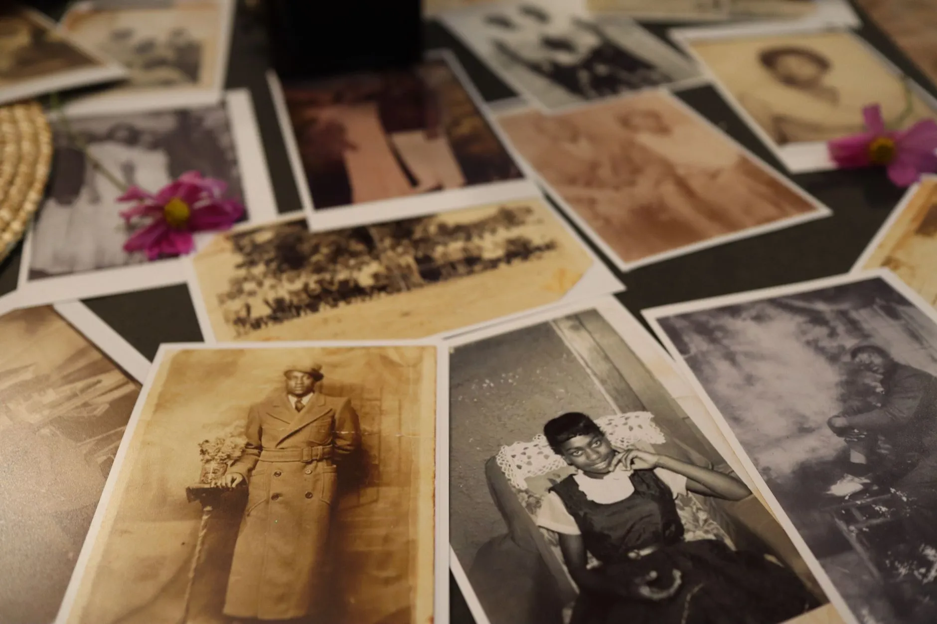 A close spread of old photographs laid out on a table